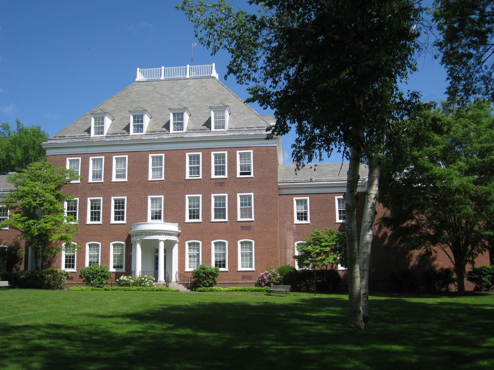 A brick campus building behind a lawn and trees in Wallingford, Connecticut